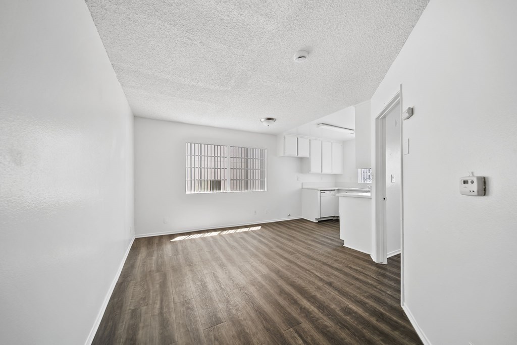 A room with wooden floors and white walls.