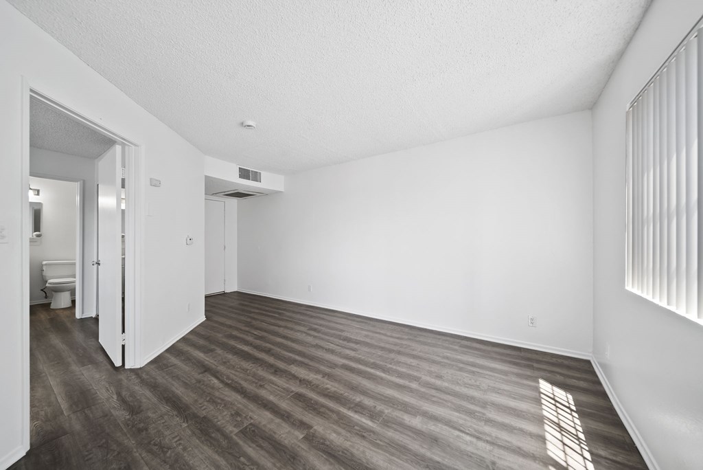 A room with a wooden floor and white walls.