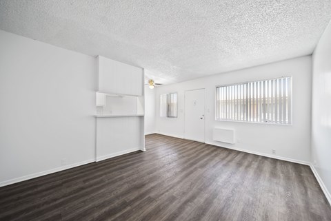 A room with wooden floors and white walls.
