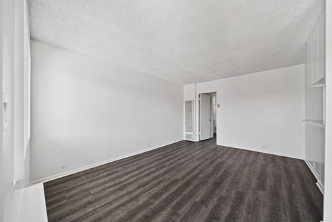 A room with a wooden floor and white walls.