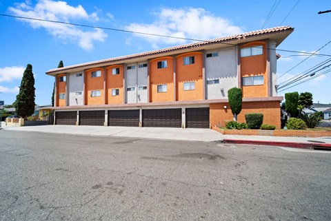 A building with orange and white walls and a red roof.