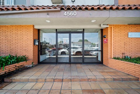 The entrance to a building with a glass door and a sign that reads "4560".