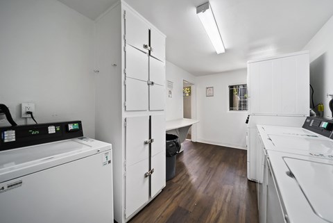 A white laundry room with a washer and dryer.