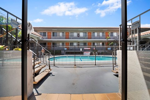 A pool area with a building in the background.