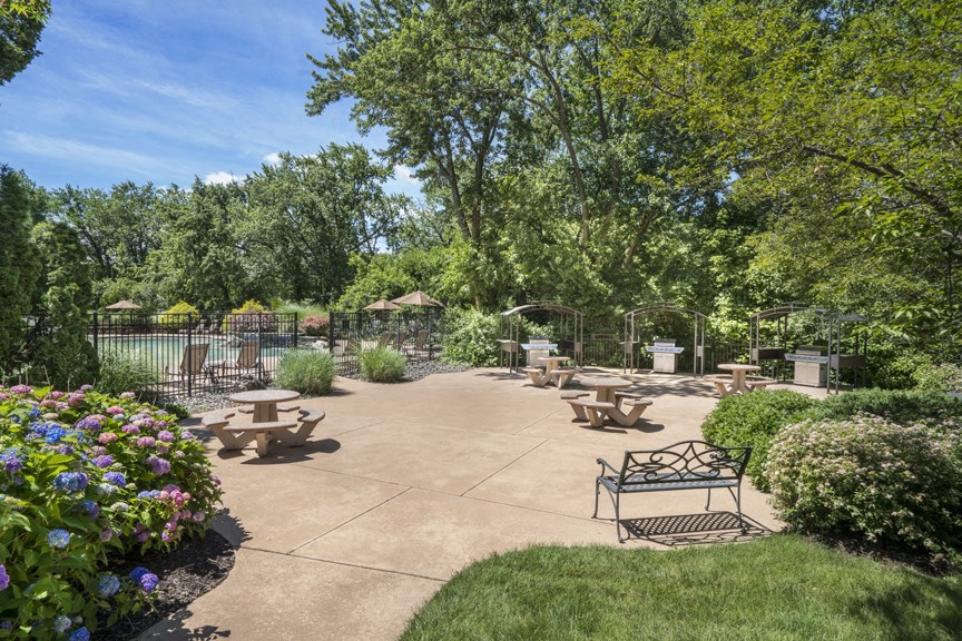 A park with a bench and a flower bed at Rivercrest Apartments, Piscataway  08854