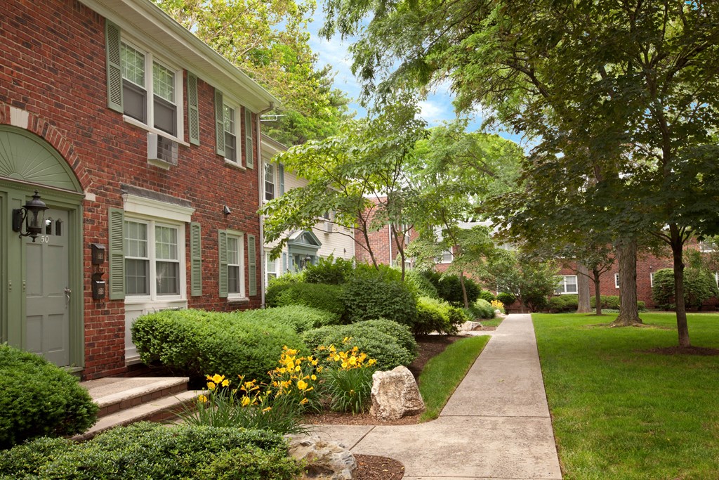 A residential street with a sidewalk and greenery. at Rivercrest Apartments, New Jersey