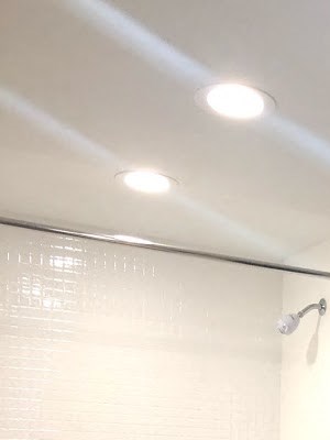1 Bedroom Renovated Bathroom A white toilet sits next to a white sink in a bathroom.