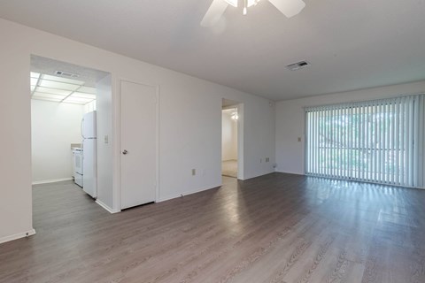 A spacious room with a ceiling fan and wooden flooring at Imperial Gardens Apartments, Clearwater 33764