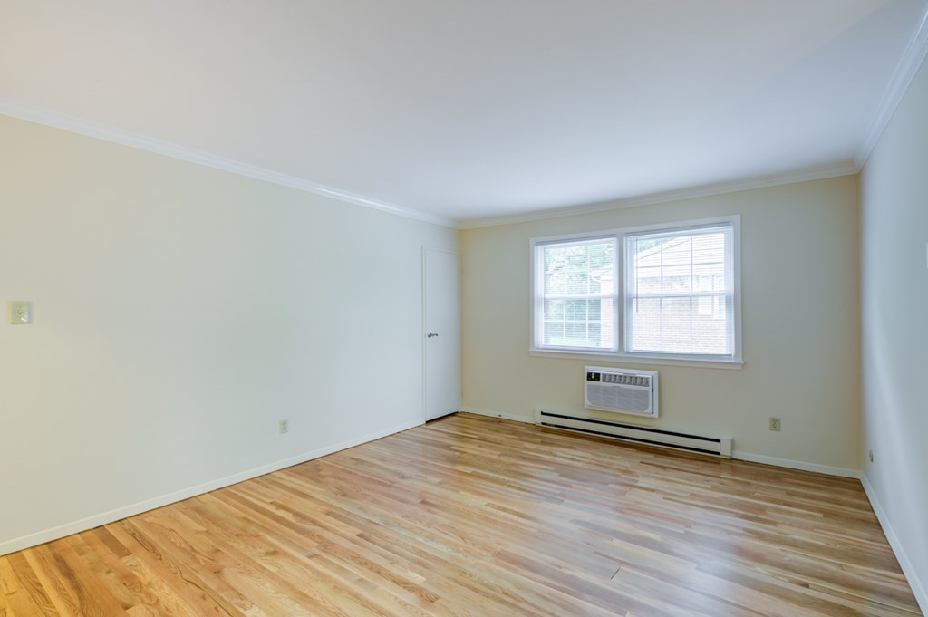 A room with a window and a radiator on the wall at Rivercrest Apartments, Piscataway