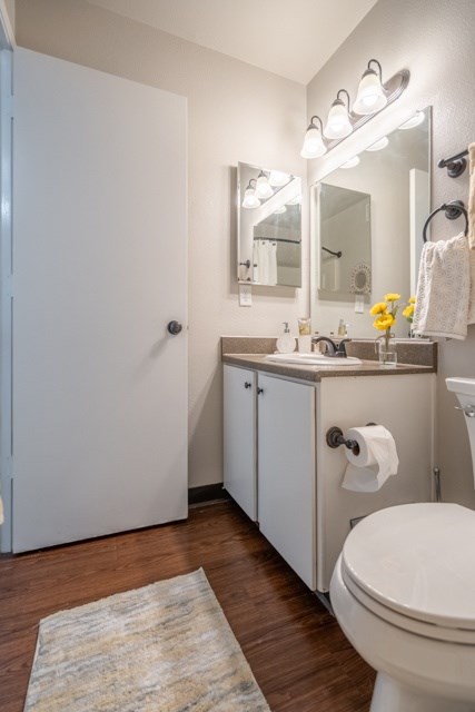 A white toilet sits next to a sink in a small bathroom.