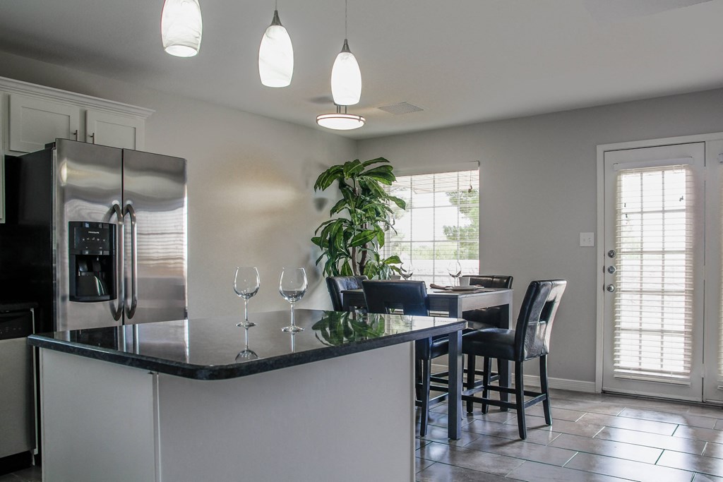 kitchen with a large island and a dining room in the background at Village of Cottonwood Springs in El Paso, TX