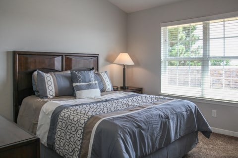 a bedroom with a large bed and oversized window at Village at Cottonwood Springs in El Paso