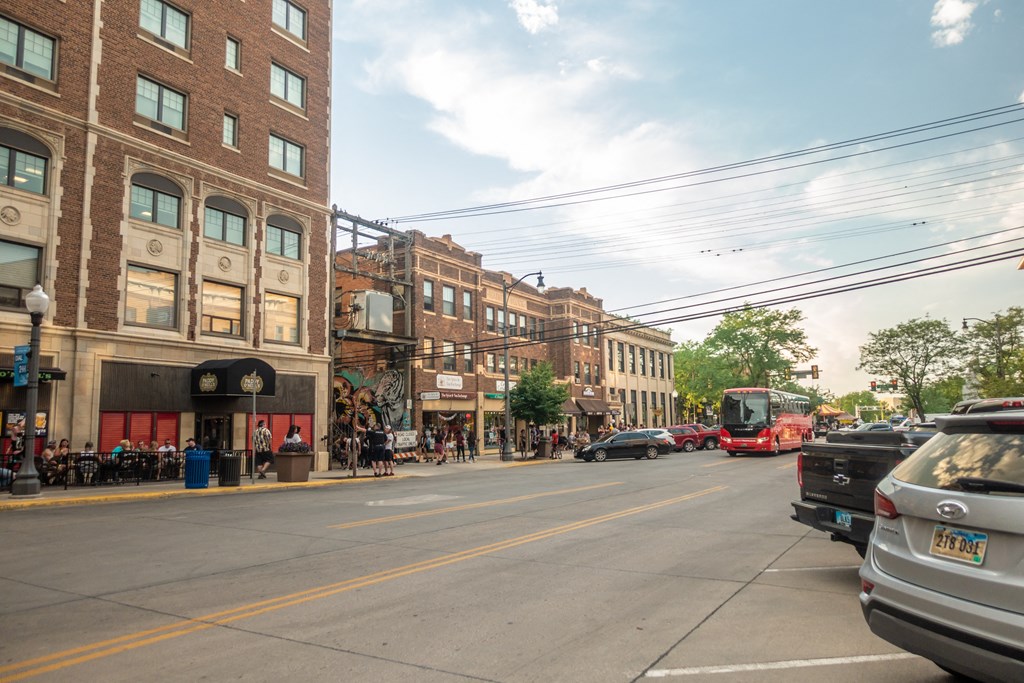 a city street with cars and buses and buildings  at Antelope Ridge, Box Elder, South Dakota
