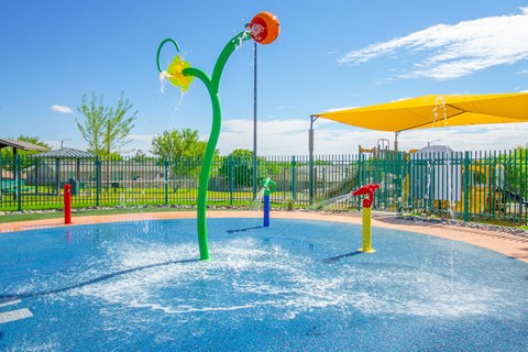 a water park with a yellow and red water slide