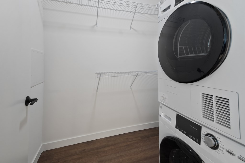 A white washing machine is in a laundry room.