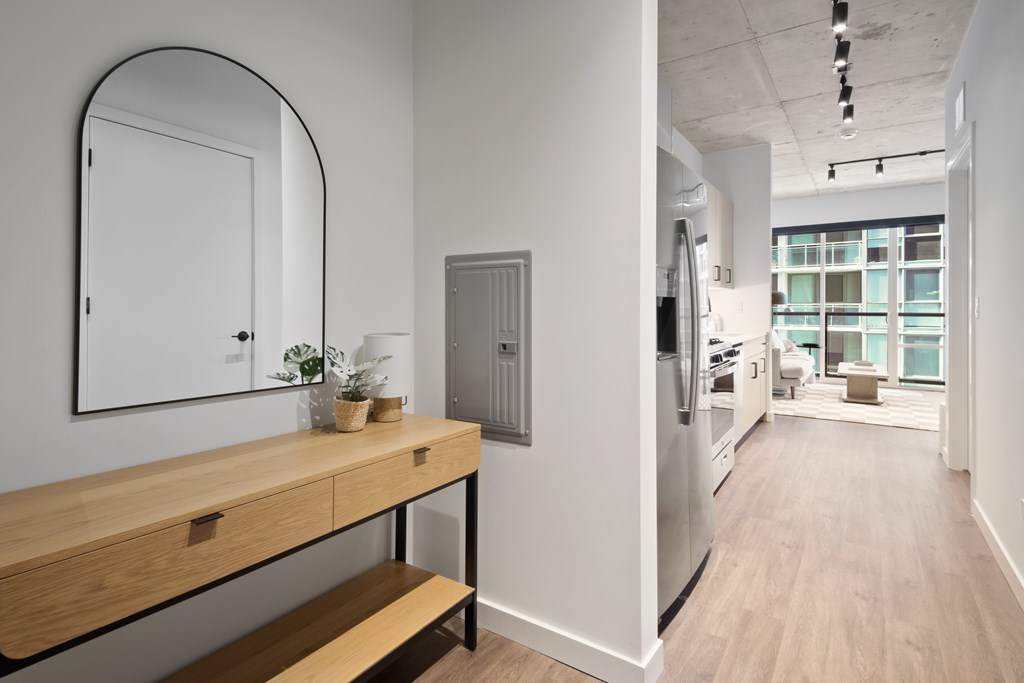 A modern kitchen with a wooden counter and stainless steel appliances.