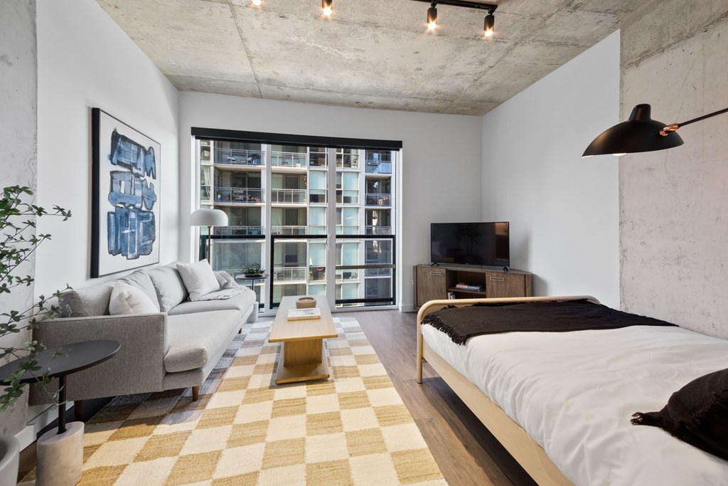 A modern bedroom with a large bed and a couch.