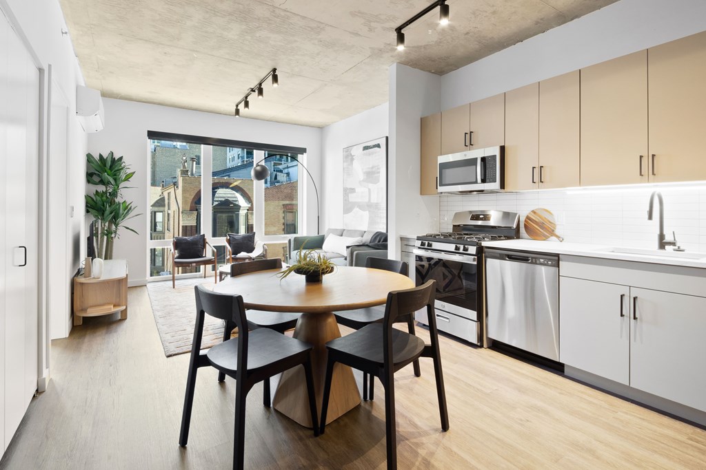 A modern kitchen with a dining table and chairs.