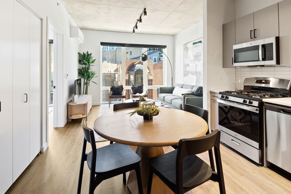 A modern kitchen with a round table and chairs.