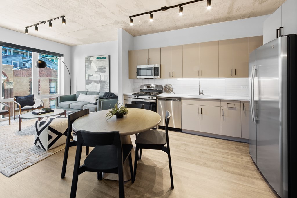 A modern kitchen with a dining table and chairs.