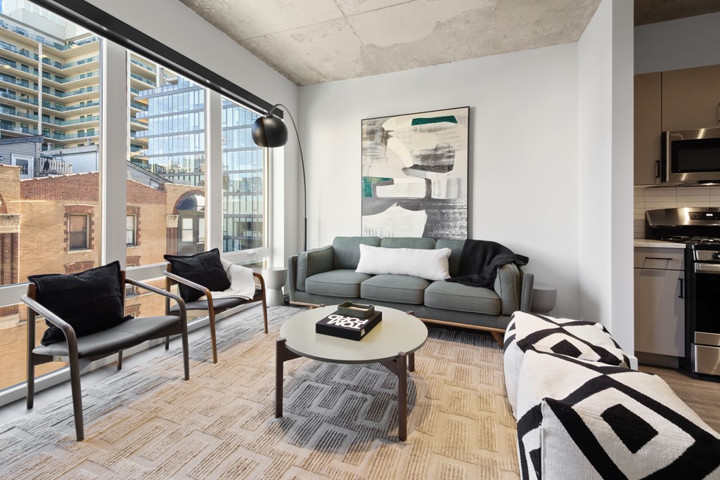 A modern living room with a grey couch and a coffee table.