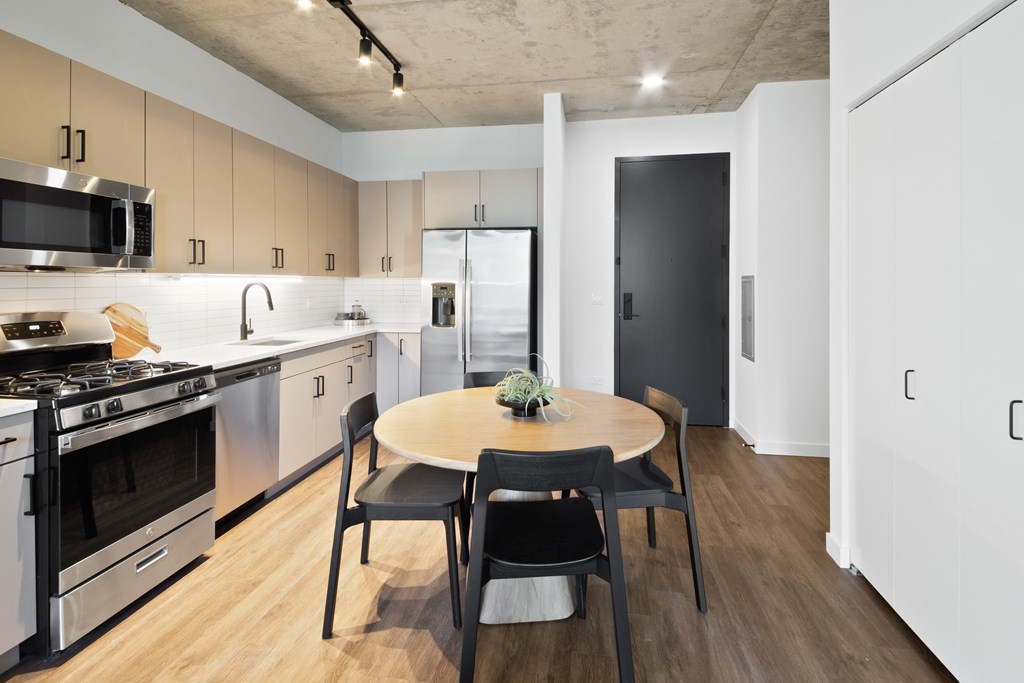 A modern kitchen with a table and chairs.