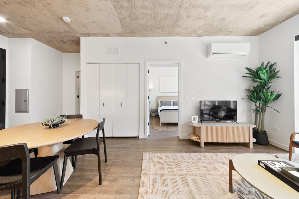 A modern living room with a wooden table and chairs.