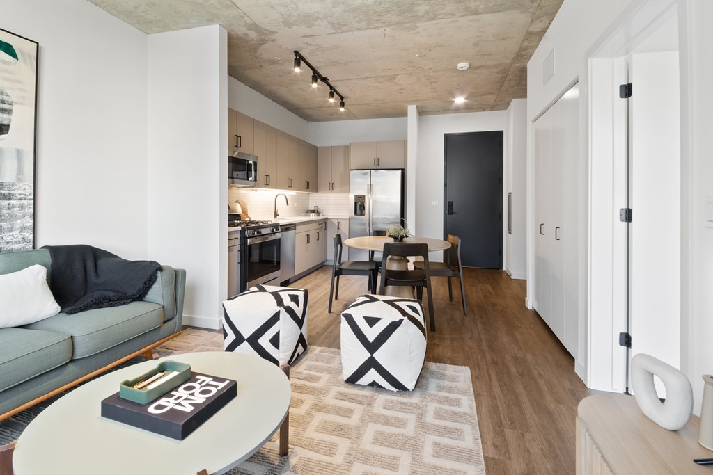 A modern living room with a grey sofa and a coffee table with a book on it.