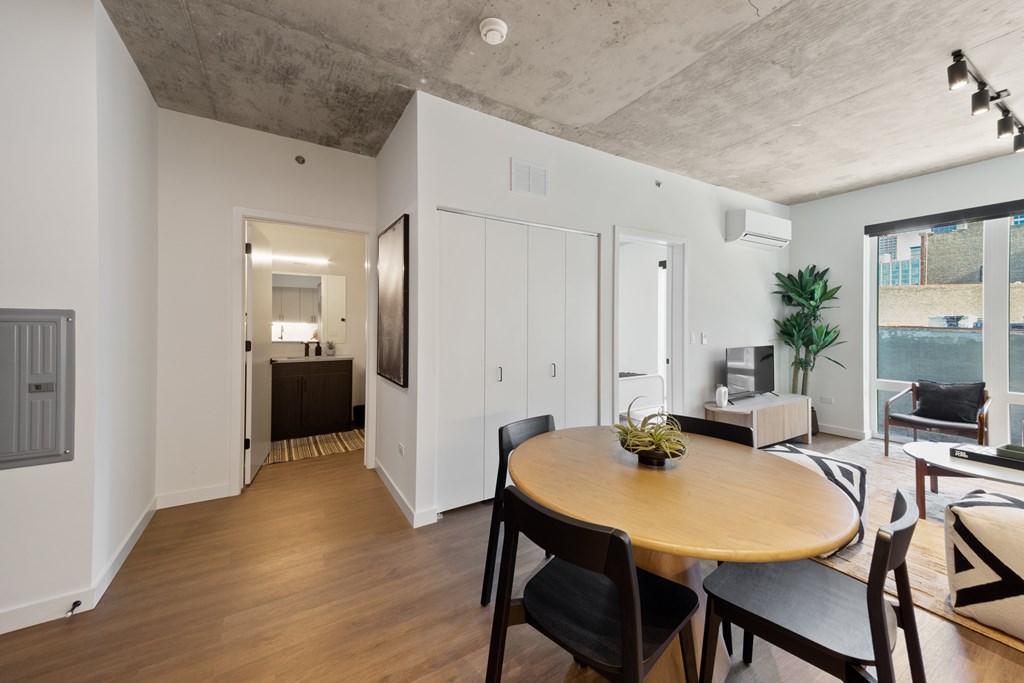 A dining room with a wooden table and chairs.
