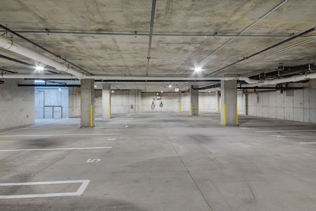 A spacious, empty parking garage with concrete floors and walls.