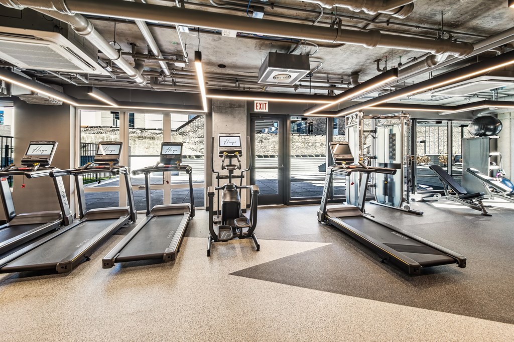 A gym with treadmills and exercise equipment.