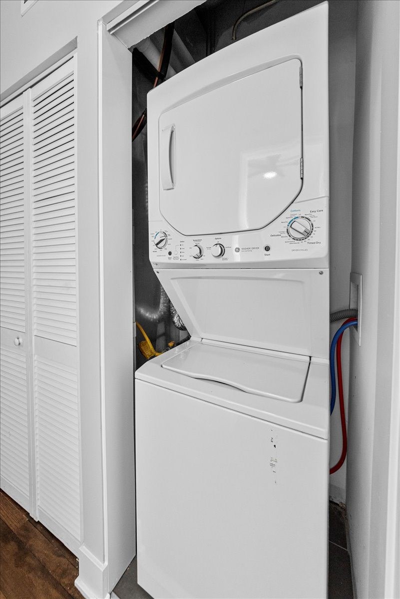 A white dryer is in a cabinet.