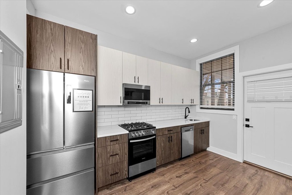 A modern kitchen with wooden cabinets and stainless steel appliances.