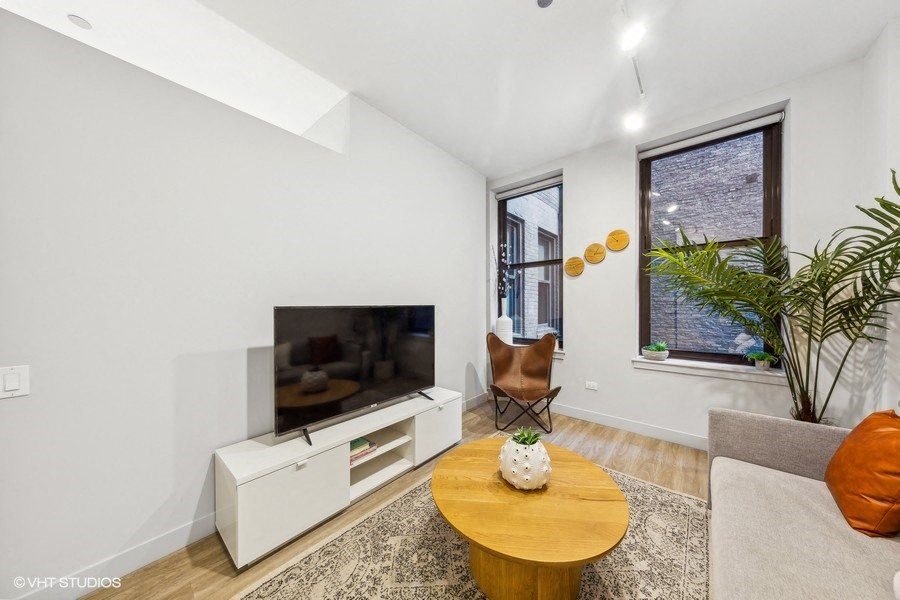 a living room with a couch and a table and a television