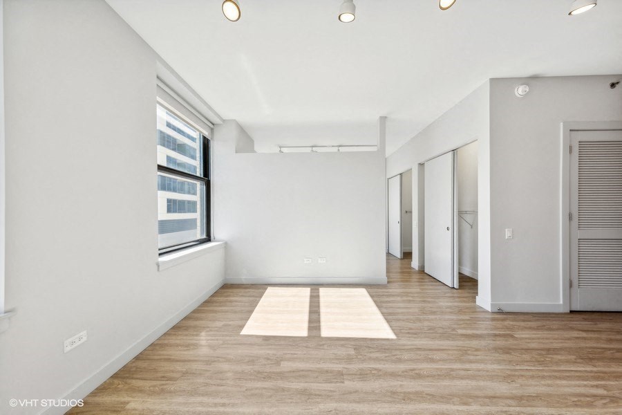an empty room with white walls and a window