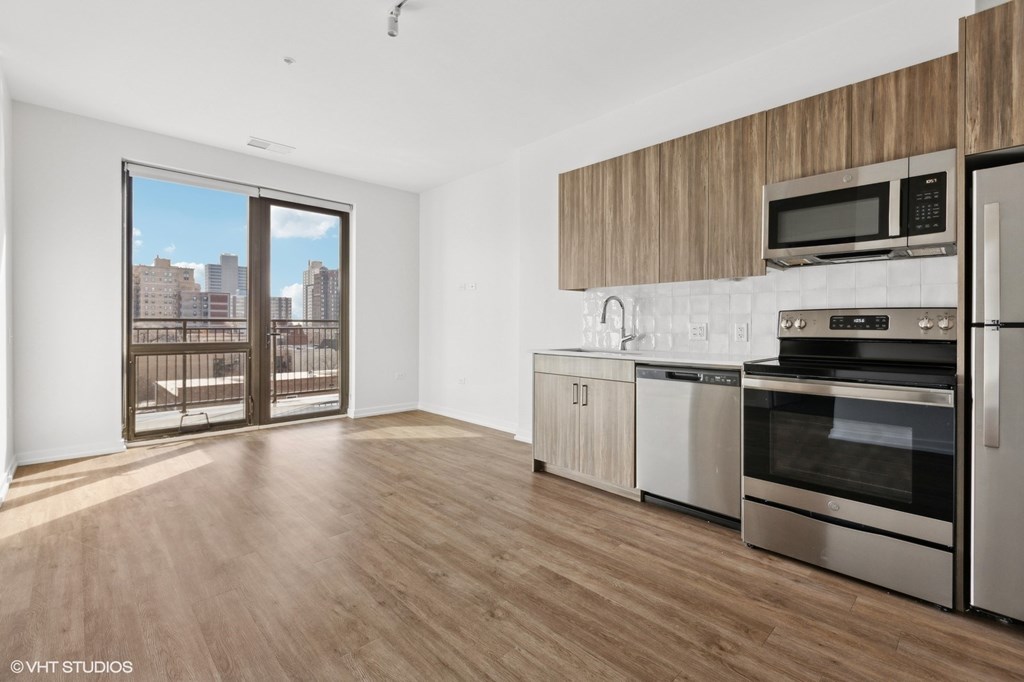 A kitchen with wooden cabinets and stainless steel appliances.