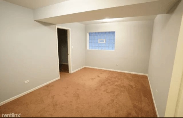 a empty room with a blue and white wall and a carpet
