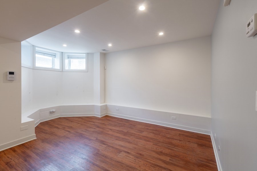 A room with wooden floors and white walls.