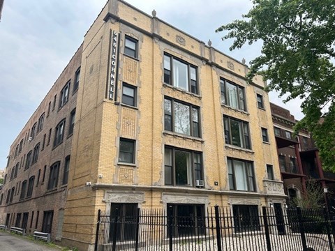 A tall brick building with a sign on the side.