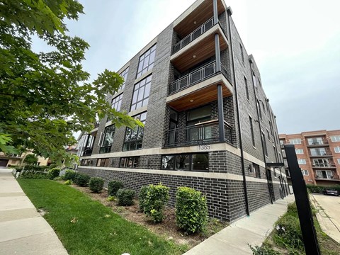 A modern apartment building with balconies and windows.