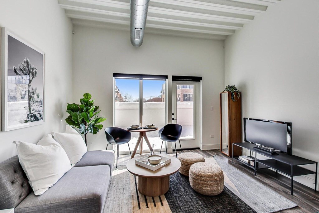 a living area with a couch coffee table and a tv