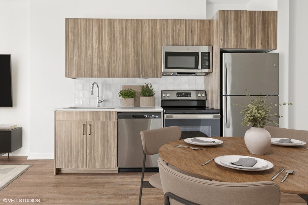 A modern kitchen with a wooden cabinet and stainless steel appliances.