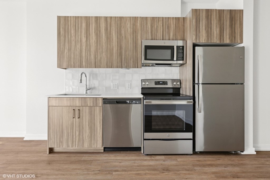 A modern kitchen with a wooden cabinet and stainless steel appliances.