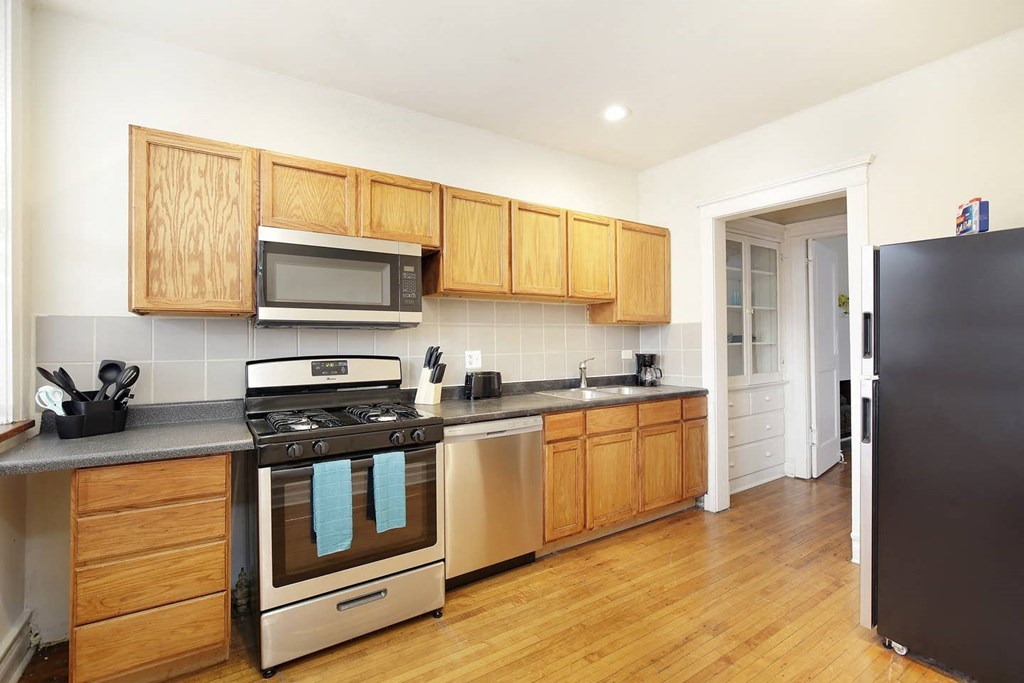 a kitchen with stainless steel appliances and wooden cabinets
