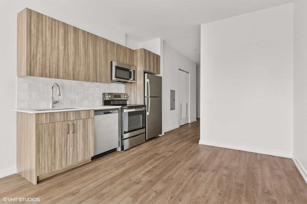 A kitchen with wooden cabinets and a white countertop.