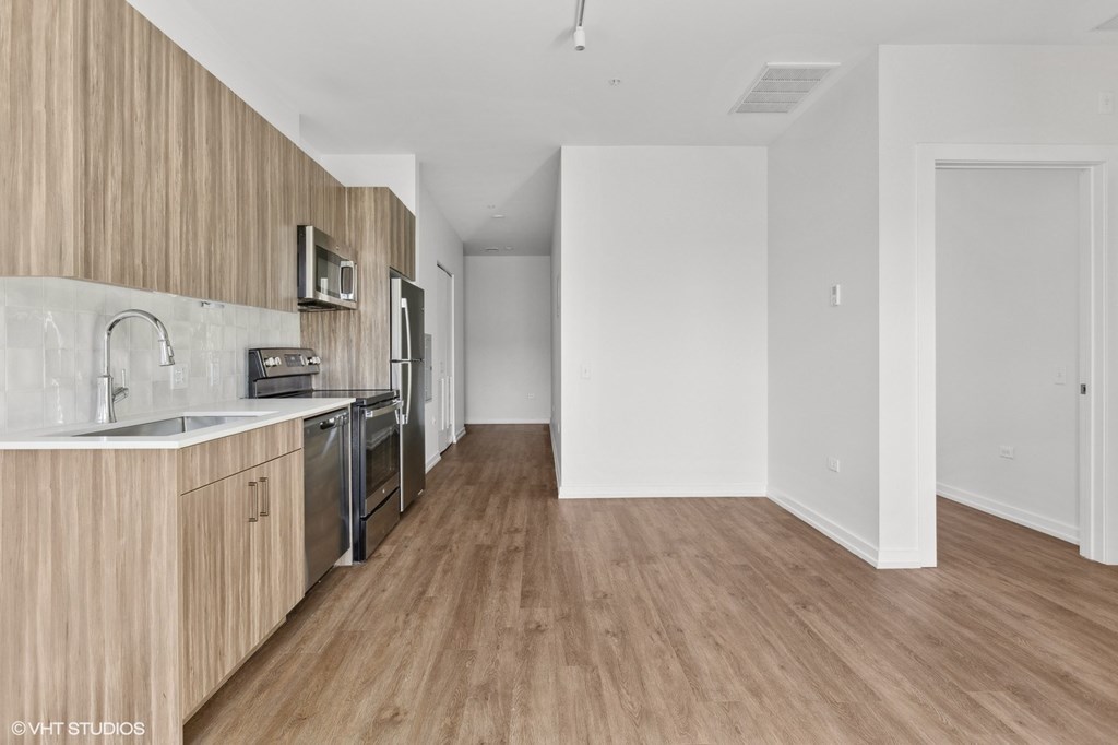 A kitchen with wooden cabinets and a white countertop.