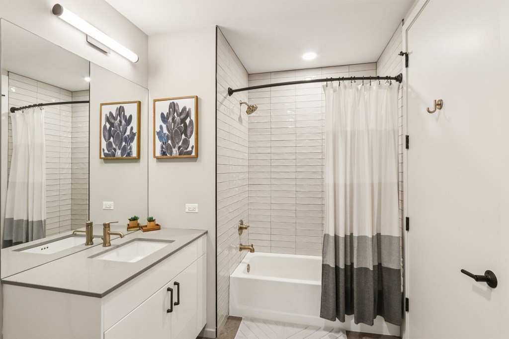 A white bathroom with a white tub and sink.