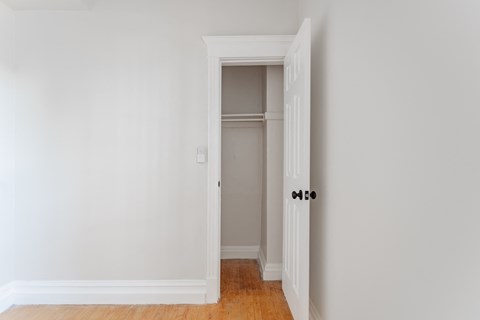 A white door is open to a hallway.