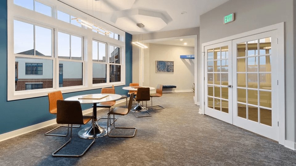 A conference room with a long table and chairs.