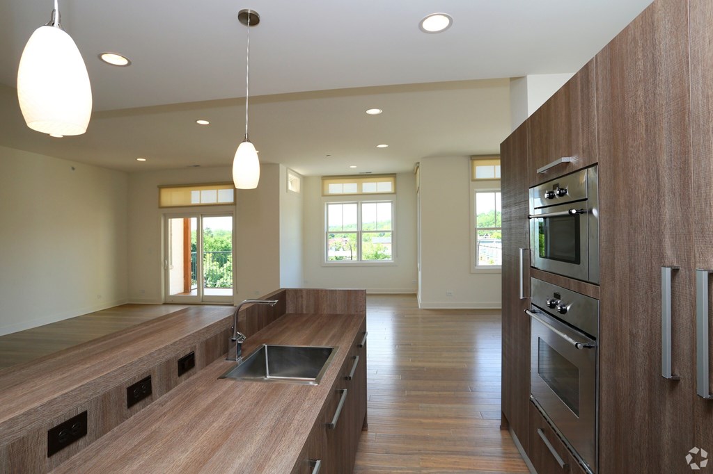 A modern kitchen with wooden cabinets and a central island.